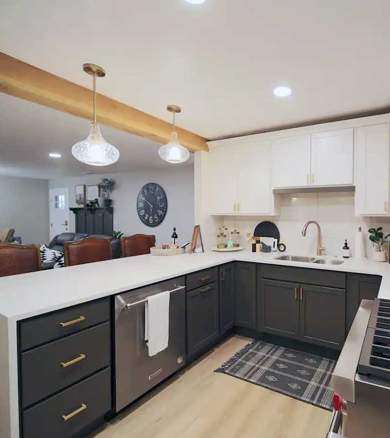 Close up of dark brown kitchen cabinets with grey and white countertops